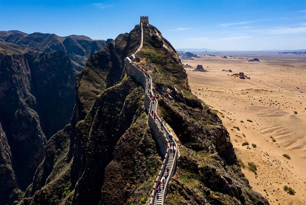 Hikers climbing the steep stairs of the Overhanging Great Wall panoramic view of Gobi plain
