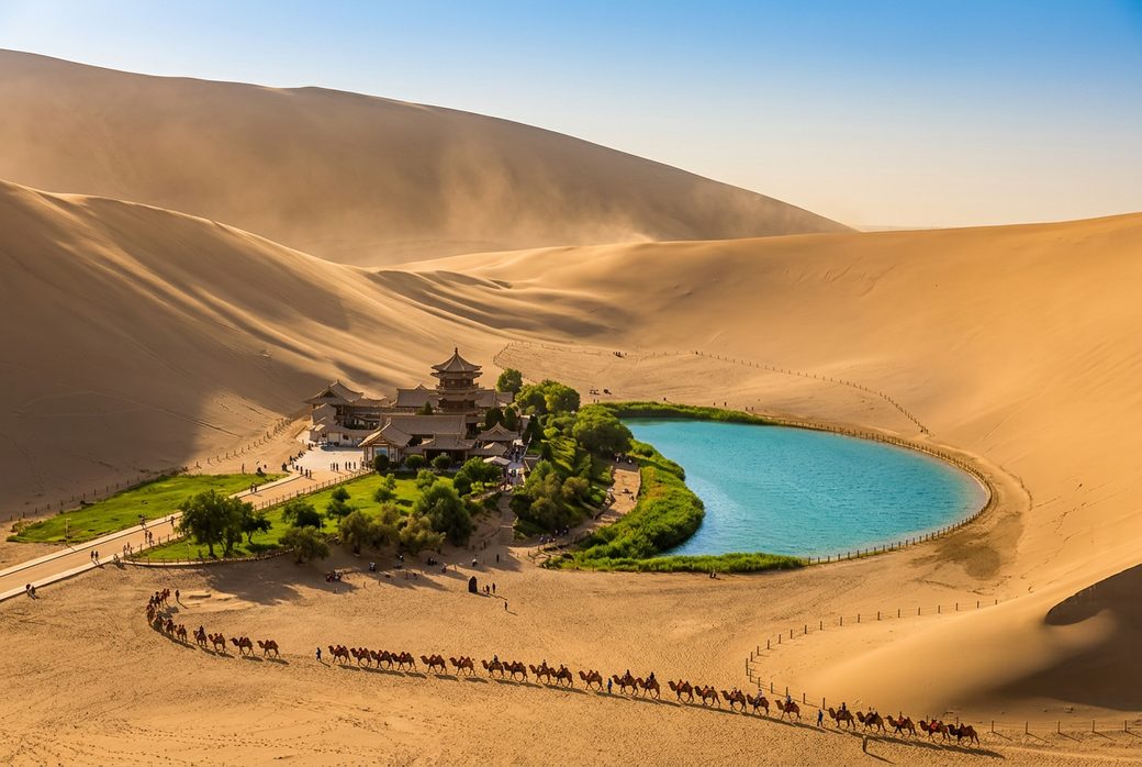Mingsha Dunes Crescent Lake Dunhuang crescent shaped spring beneath towering sand dunes golden hour camel caravan
