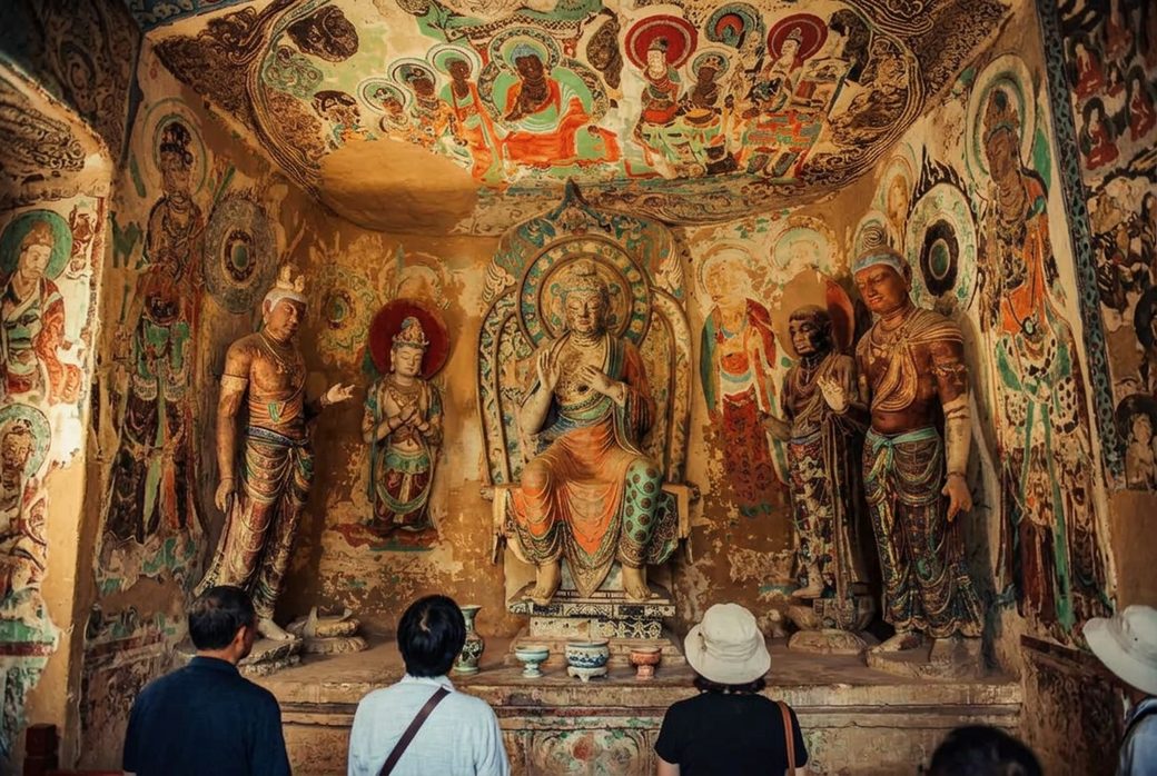 Colourful Buddhist murals inside a Mogao cave