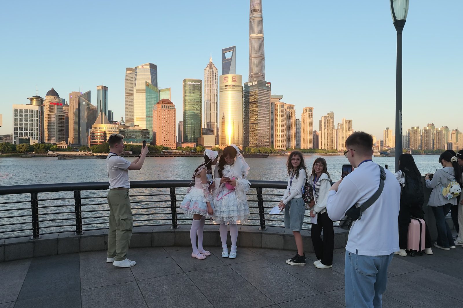 The Pudong skyline across the Huangpu River from the Bund promenade in Shanghai at sunset