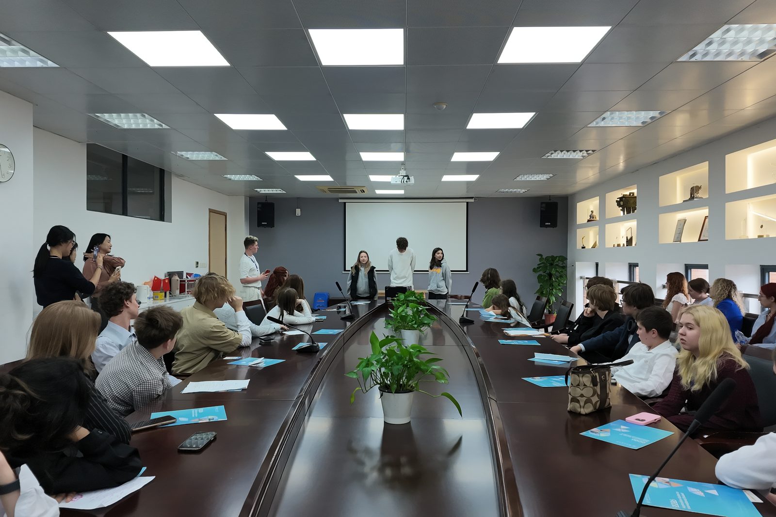 A long meeting room on a university campus in Hangzhou, set up for a student presentation session