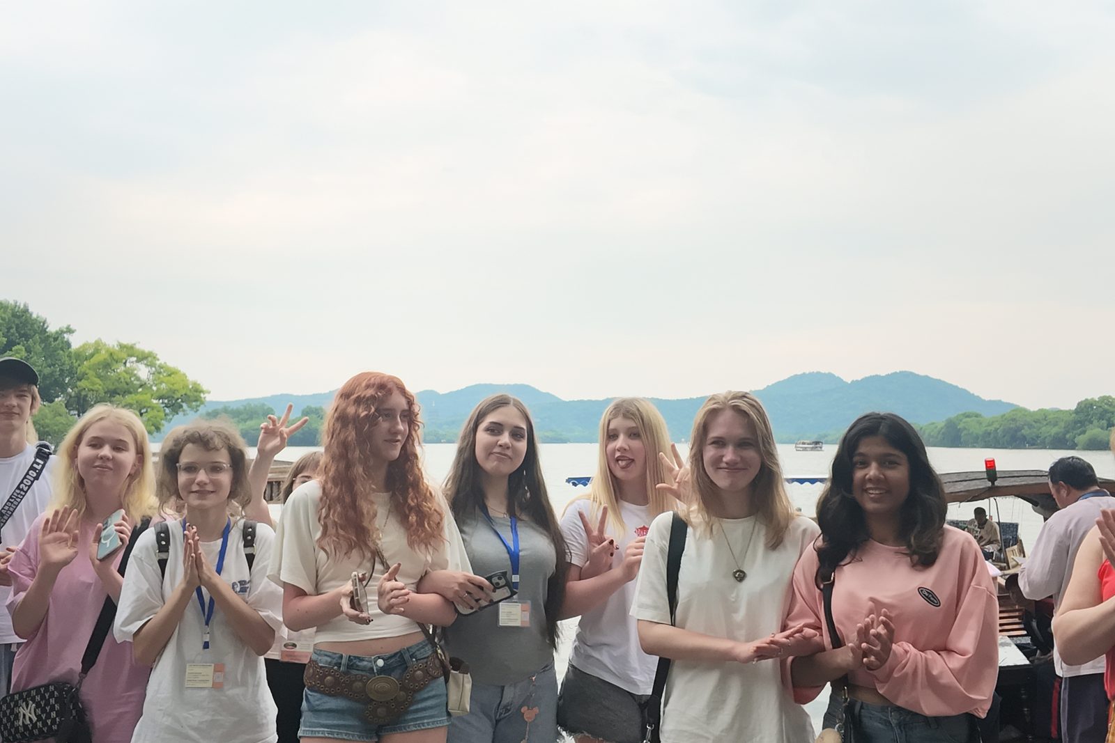 Students smiling together on the shore of West Lake in Hangzhou